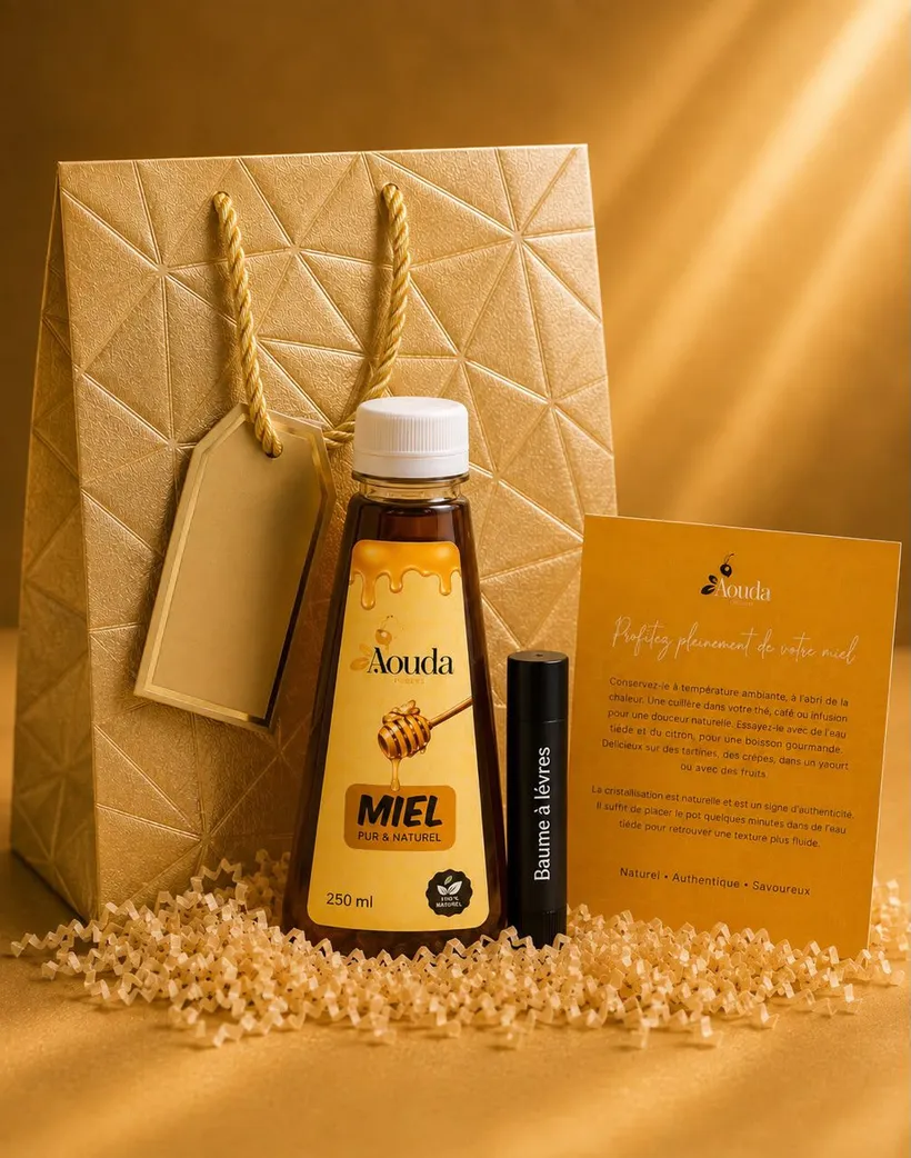 Box Aouda : sac cadeau doré, bouteille de miel Aouda 250 ml, baume à lèvres et carte de conseils